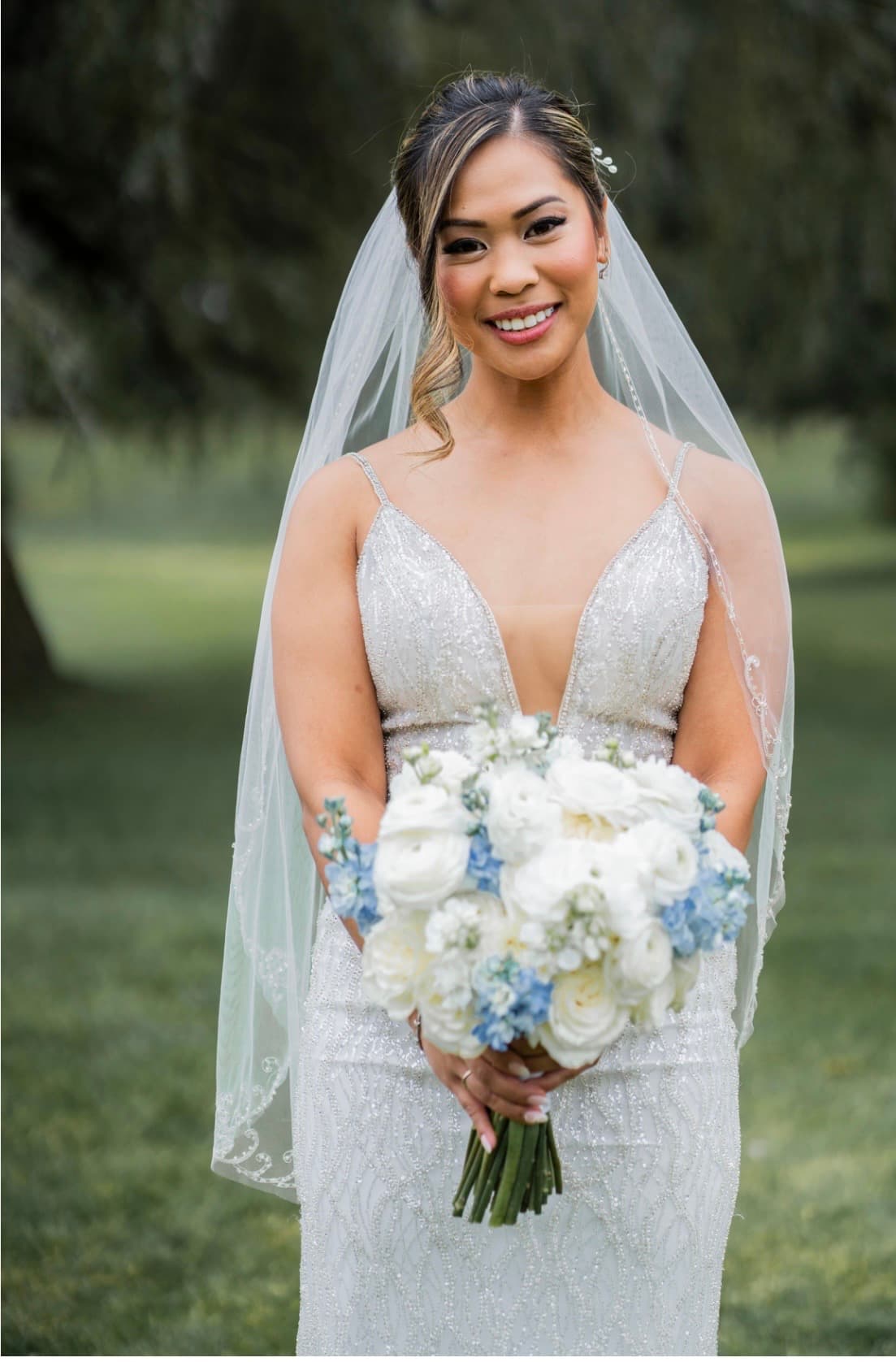 Bride portrait with bouquet showcasing natural radiant makeup