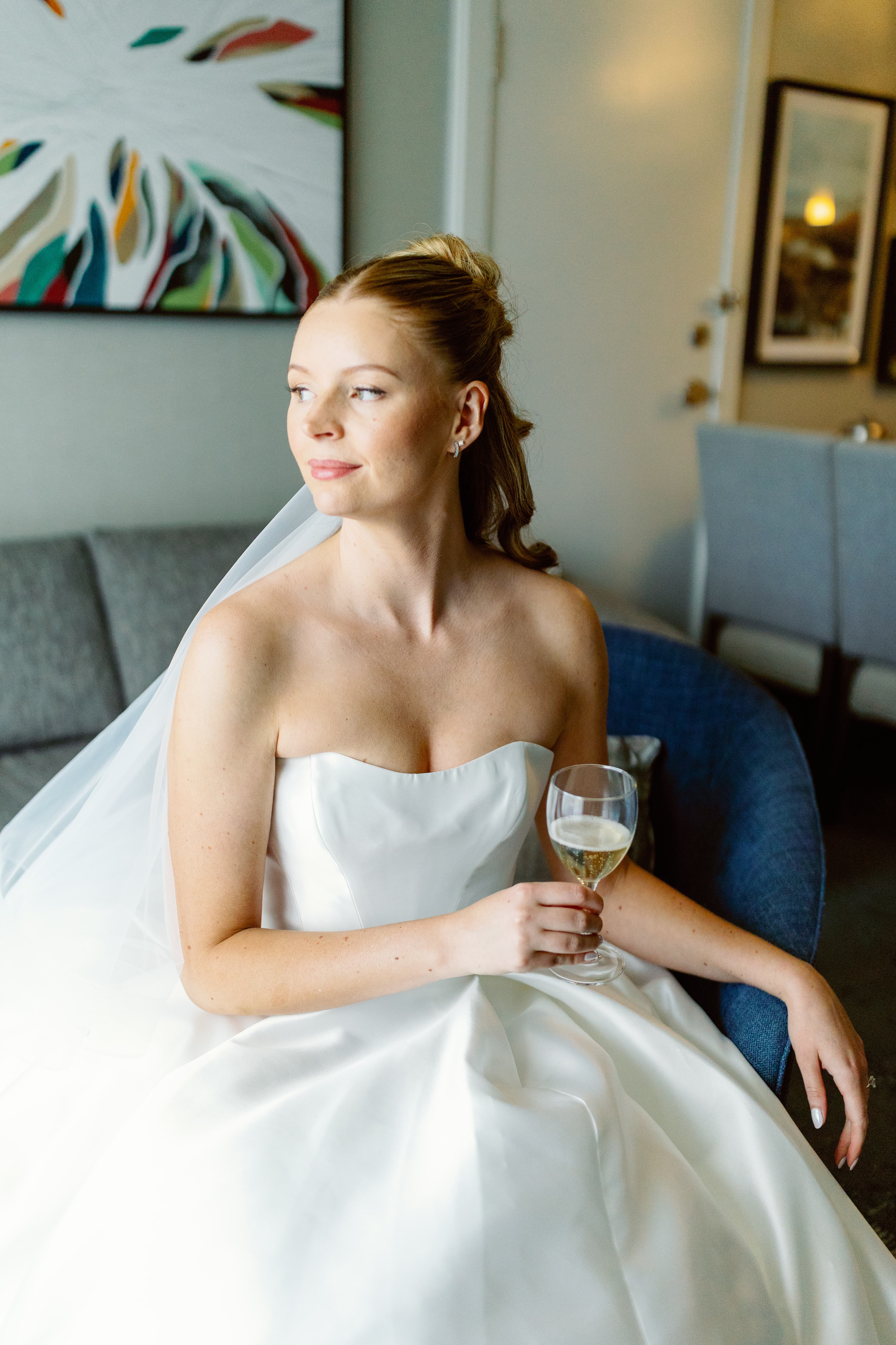 Bride seated elegantly with champagne glass