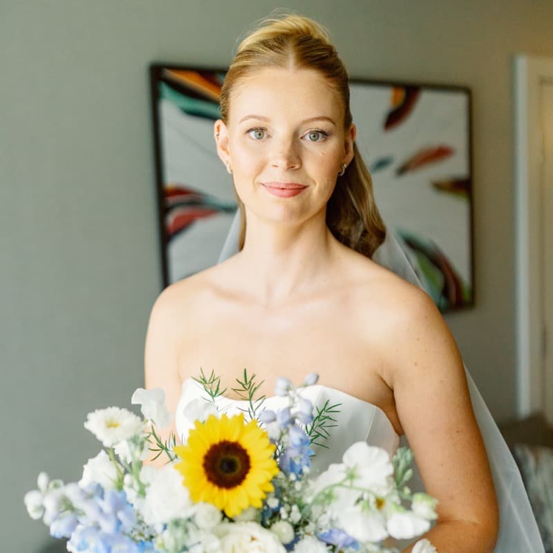 Bride with sunflower bouquet wearing natural radiant makeup