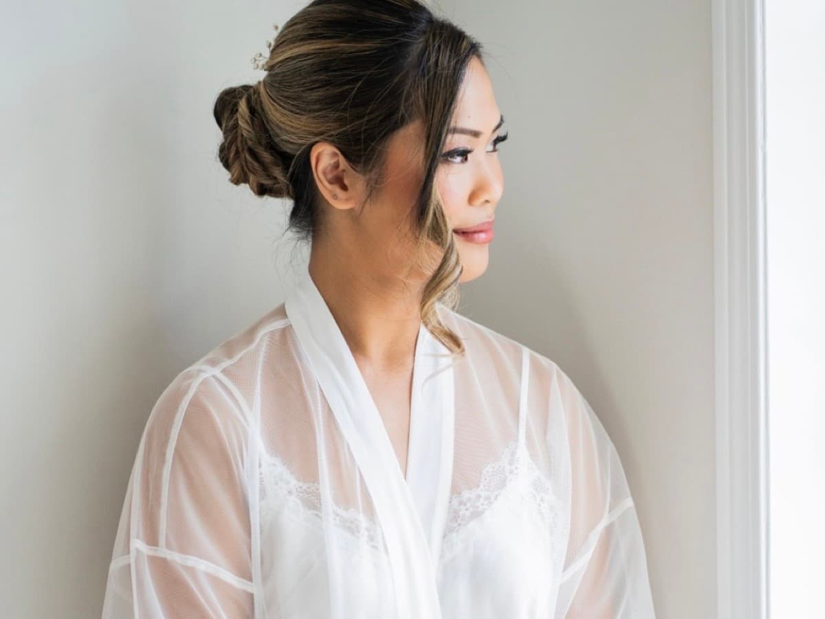 Bride in soft morning light with elegant bridal makeup by TTW Beauty